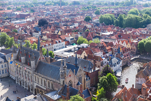 Panorama of the central part of Bruges. Top view on the background of the red roofs of the city. Belgium. High quality photo