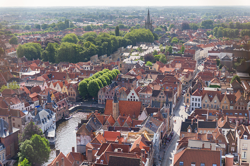 Panorama of the central part of Bruges. Top view on the background of the red roofs of the city. Belgium. High quality photo