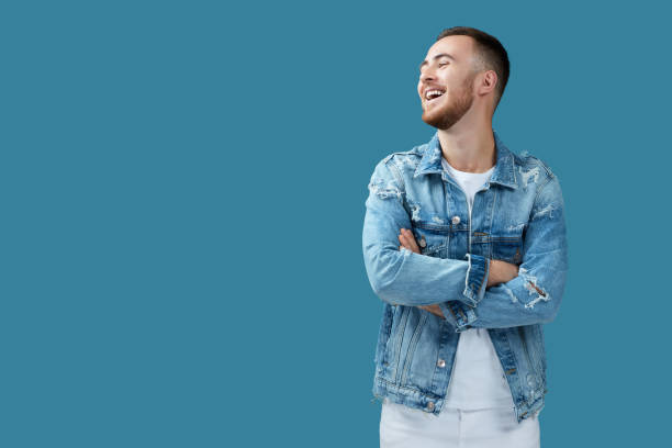 istock handsome smiling man in denim looking away 1290862994