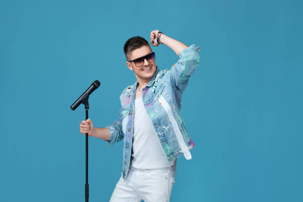 istock handsome singing man in denim with microphone 1290863759
