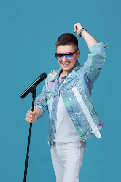 istock handsome singing man in denim with microphone 1290863954