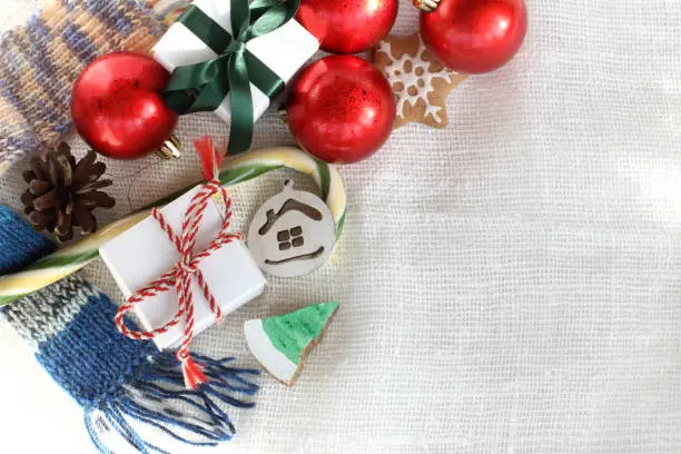 gifts, Christmas decorations, gingerbread and sweet striped staves on the tablecloth top view
