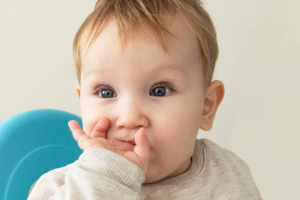 istock Little boy is sucking his fingers because his teeth are itchy 1290865683
