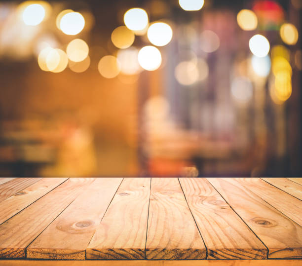 istock Wood table top (Bar) with blur light bokeh in dark night cafe,restaurant background 1290867205