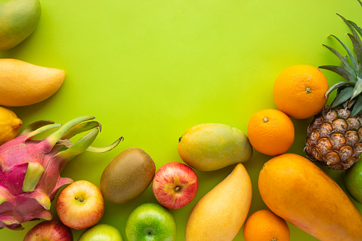 Group of fruits on green space background