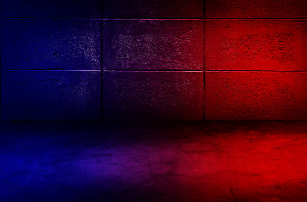 istock Studio dark room with lighting effect red and blue on concrete wall grunge texture background. 1290868295