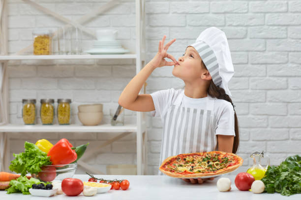 child making tasty delicious gesture by kissing fingers. - pizza sauces chef making imagens e fotografias de stock