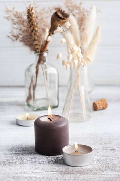 istock Lit aroma candle and dry flowers 1290870944