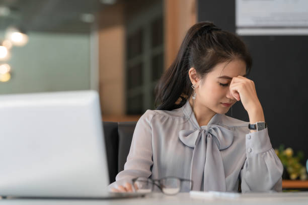 istock Asian women Stressful Working with a notebook for a long time. 1290871522