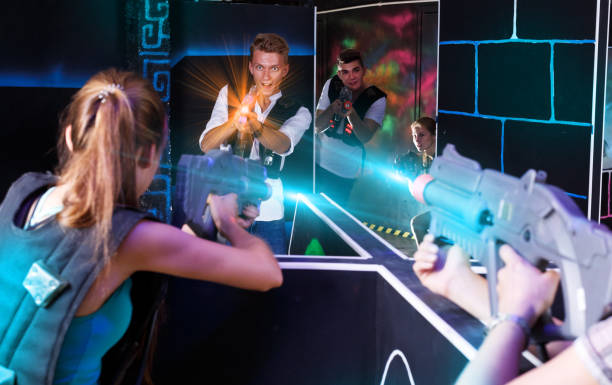 istock Excited people playing enthusiastically laser tag game 1290872060
