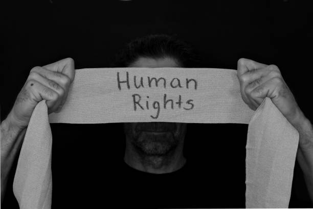 istock bearded man with bandage, gauze banner in Hand with the text human rights 1290872103