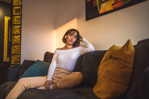 istock Young woman relaxing at home on couch, enjoying weekends 1290874012