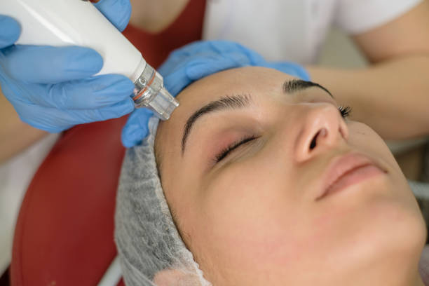 istock Cosmetologist making mesotherapy treatment on a woman's face 1290875581