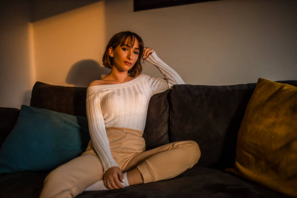istock Young woman relaxing at home on couch, enjoying weekends 1290877372