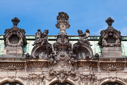 Roof detail of Dresden Zwinger. Dresden was made by architect Matthäus Daniel Pöppelmann and sculptor Balthasar Permoser in 1728