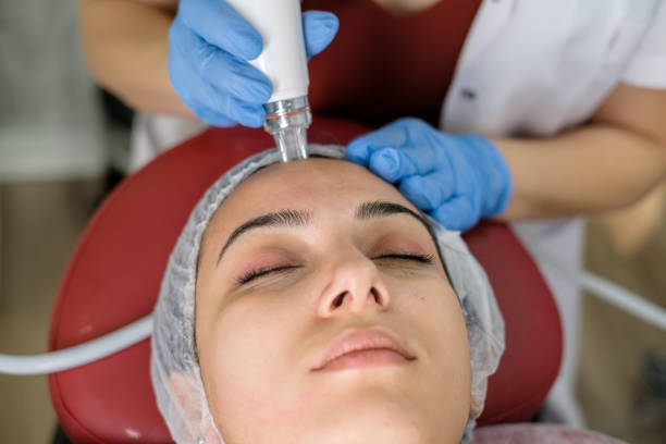 istock Cosmetologist making mesotherapy treatment on a woman's face 1290877622