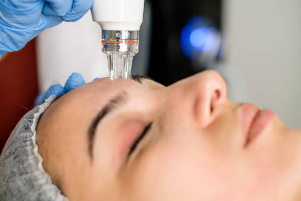 istock Cosmetologist making mesotherapy treatment on a woman's face 1290877632