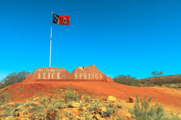 Alice Springs Welcome Alice Springs Welcome Sign and Australian Flag of Northern Territory in Central Australia. Tourism in Outback Red Center desert. Blue sky with copy space. alice springs photos stock pictures, royalty-free photos & images