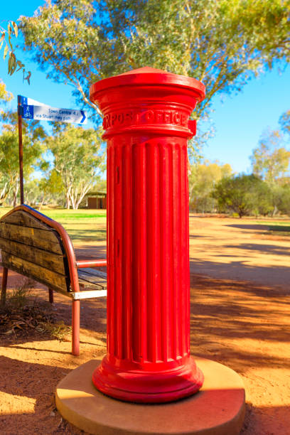 Antique red mailbox of post office of the old telegraph station in Alice Springs. A historic landmark in Alice Springs, Northern Territory, Central Australia. vertical shot.