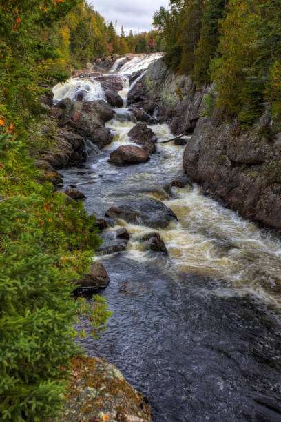 istock Vertical of Lower Sand River Falls in Ontario, Canada 1290879219