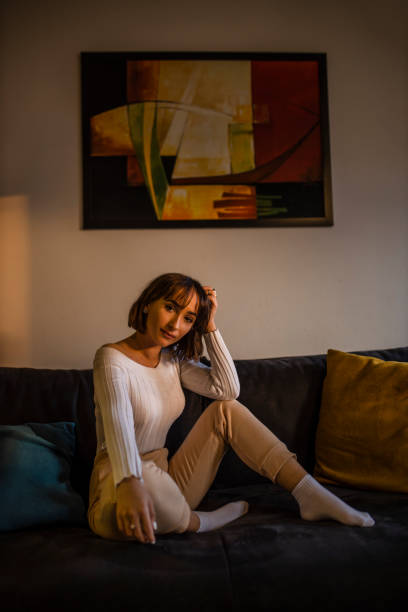 istock Young woman relaxing at home on couch, enjoying weekends 1290880540