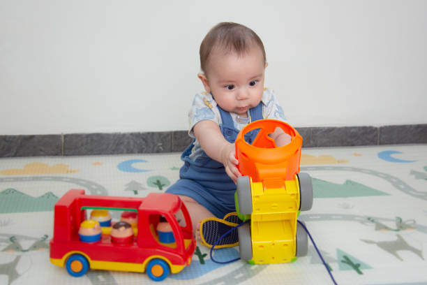 istock baby playing with colorful items 1290880565