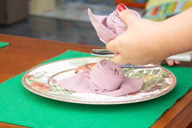 woman arranging the dishes, decorating the table