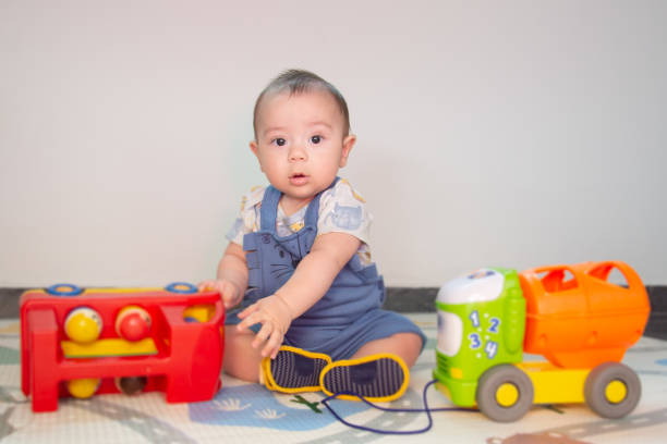 istock baby playing with colorful items 1290880749
