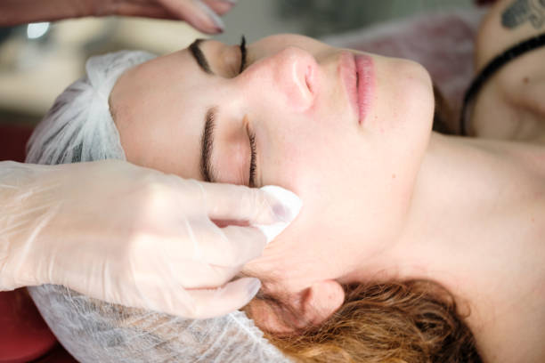 istock Cleaning face with cotton pads 1290884050