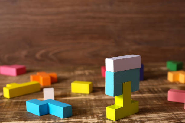 istock Multicolored puzzle, cubes on a wooden background 1290884511
