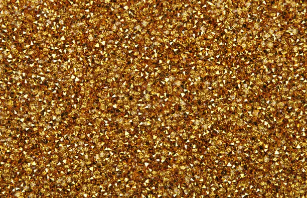 Photo of Abstract background of golden rhinestones
