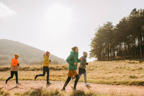 Running with a support group Photo of a group of people on a running exercise with a support group distance running stock pictures, royalty-free photos & images