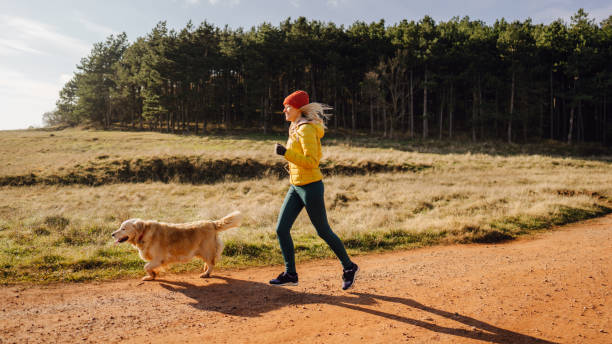istock Young woman exercising with her dog 1290888091