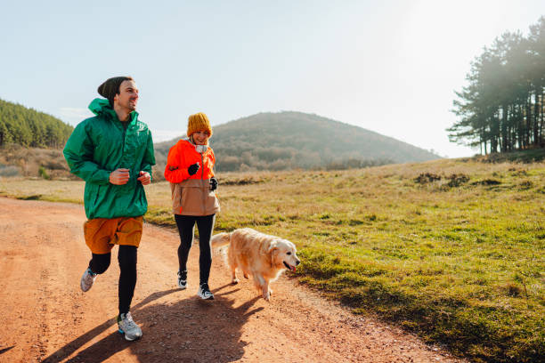 Young couple jogging together on a sunny winter day