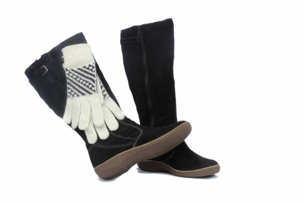 istock Black womens winter boots and white gloves. 1290889589