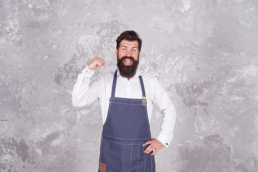 Man denim apron stylish barbershop staff bearded hipster, motivated worker concept.