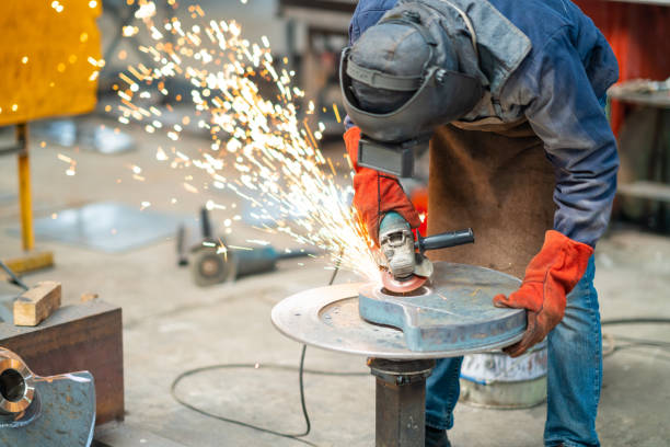 istock Worker in protective work clothes cuts iron plate in factory 1290890364