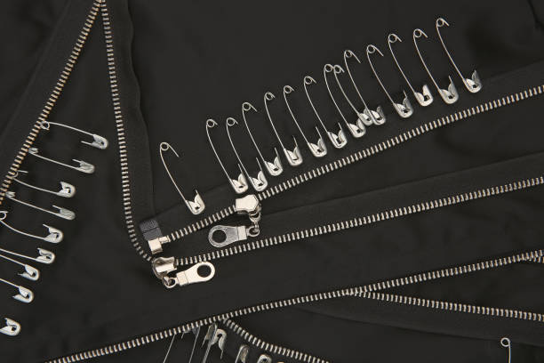 Safety pins and zippers on black fabric. Close up of subculture clothing. emo stock pictures, royalty-free photos & images