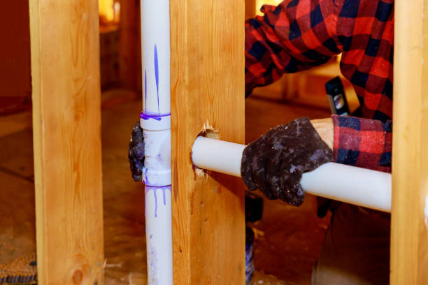 istock Mount under construction a plumber glue white PVC pipe, a new plastic drain 1290892981