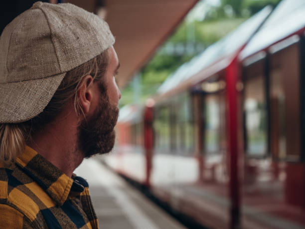 istock Man waits for train at station, side view 1290893443