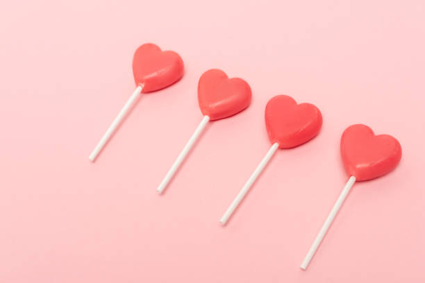 istock heart shaped lollipops on pink background 1290898252