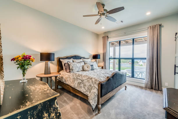 istock Large window with curtains in bedroom 1290907306
