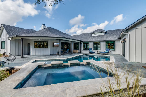 istock Custom designed swimming pool in backyard of house 1290907314