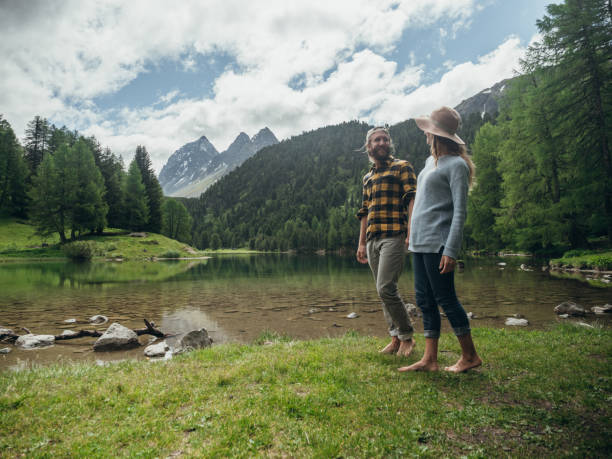 istock Couple relax by the lake in Summer 1290908625