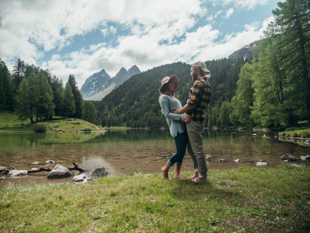 istock Couple relax by the lake in Summer 1290908678