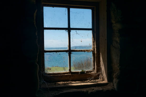 istock View to blue sky and sea through dirty old multi-paned widow 1290908981