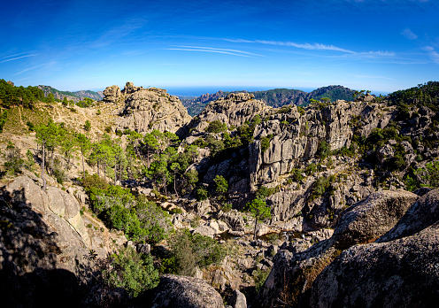 Rock formations on a plateau above the Alta Rocca mountain range on the hiking Trail to Cascade de Piscia di Gallo, the highest waterfall in Corsica, France.