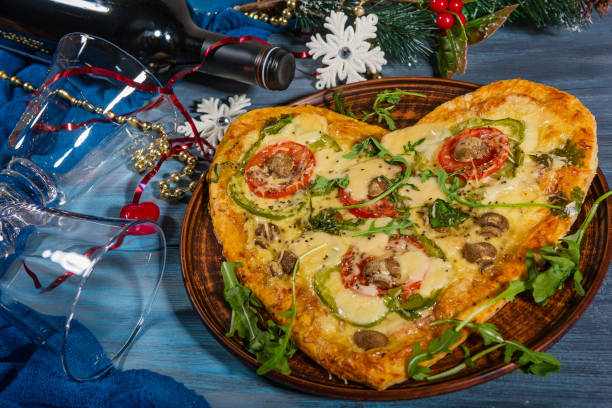 Heart-shaped pizza and a bottle of wine