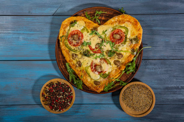 istock Pizza in the shape of a heart for two 1290910675