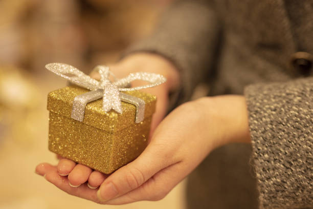 istock Woman holding a new year present 1290914033
